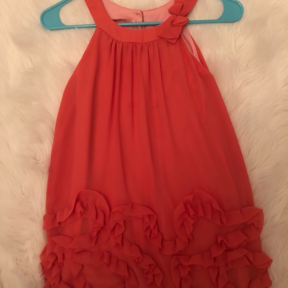 A dress with a bow attachment on the neck area.